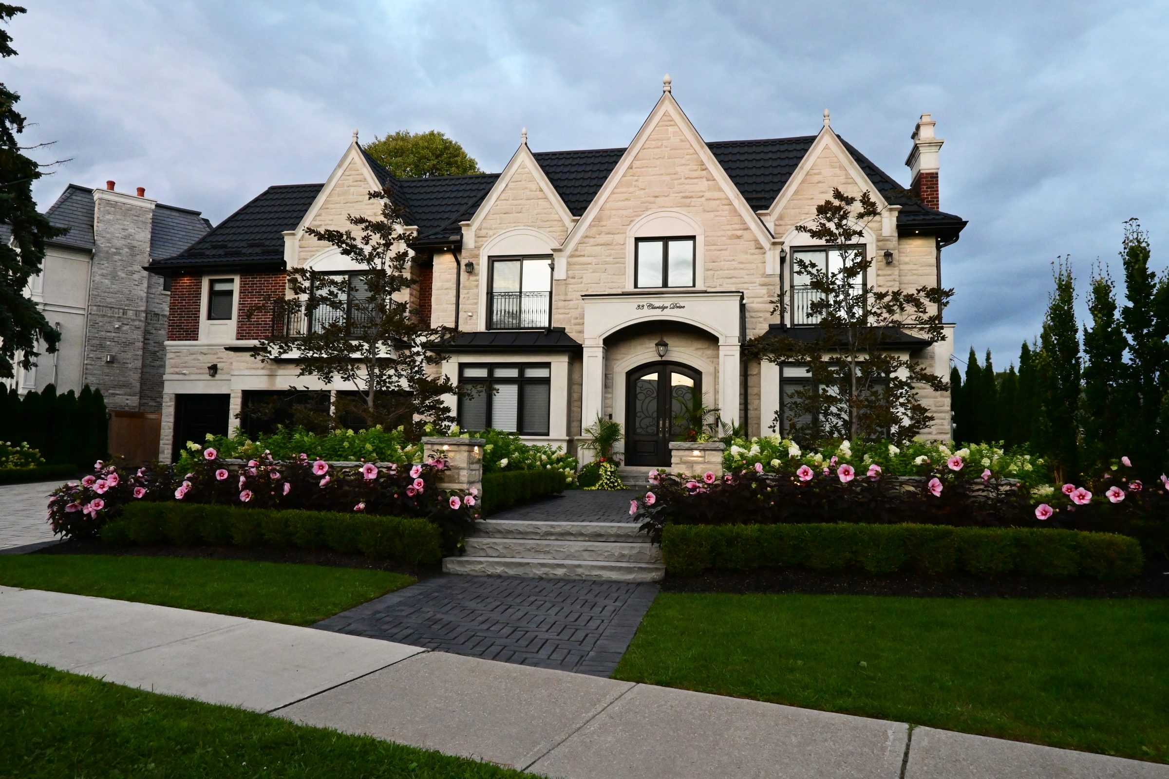 Elegant house with garden and stone pathway entrance.