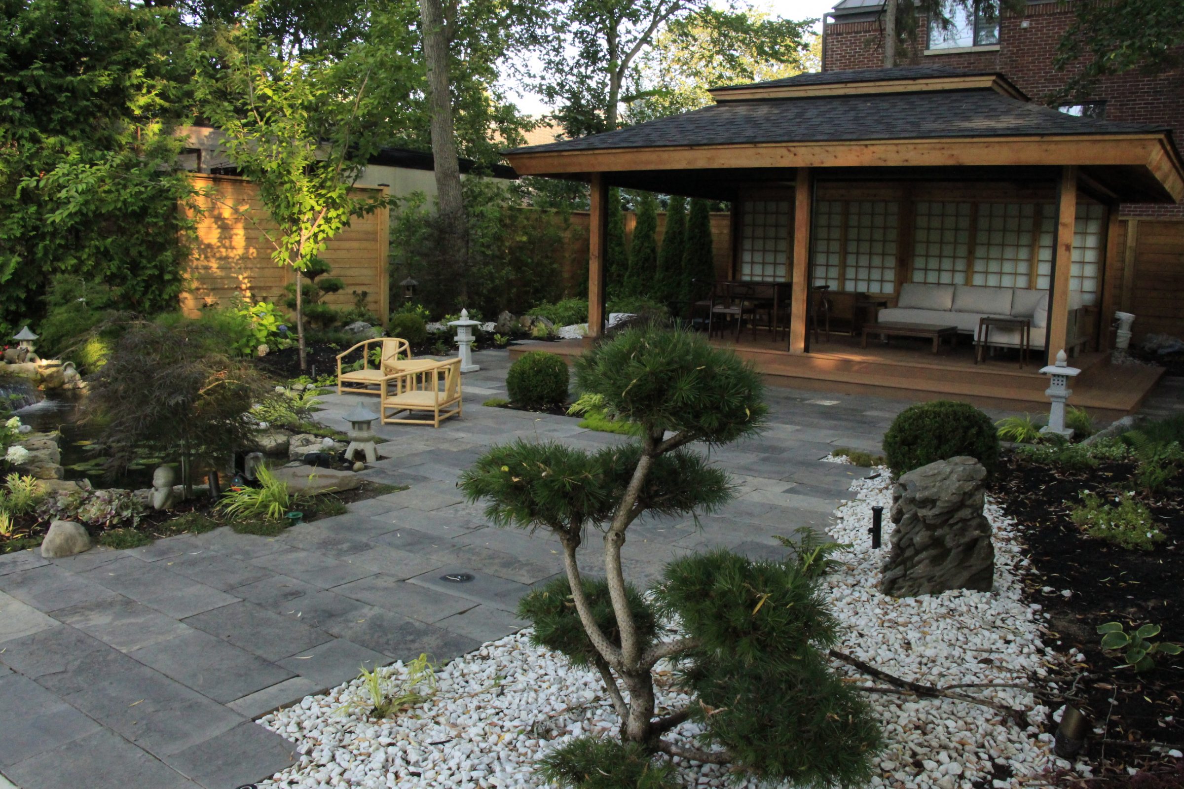 Japanese garden with pavilion and stone pathway.