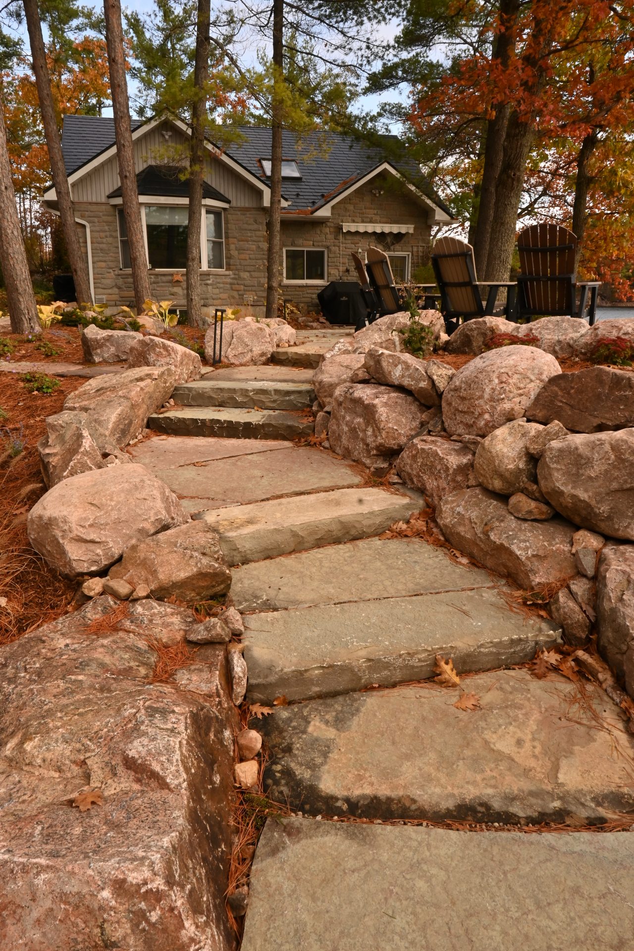Stone path leading to rustic house in fall.