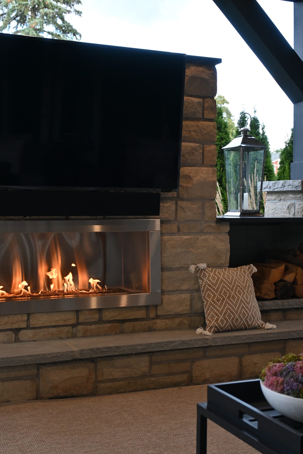 Cozy patio with fireplace and TV.