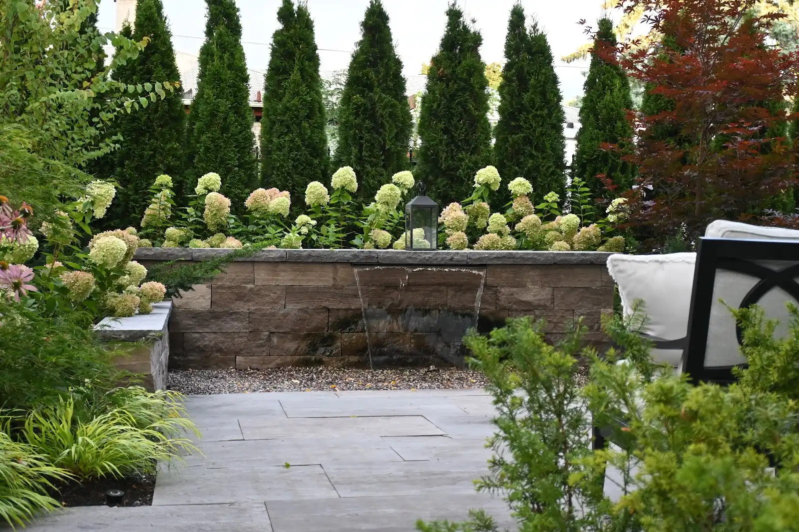 Serene garden with waterfall and lush greenery