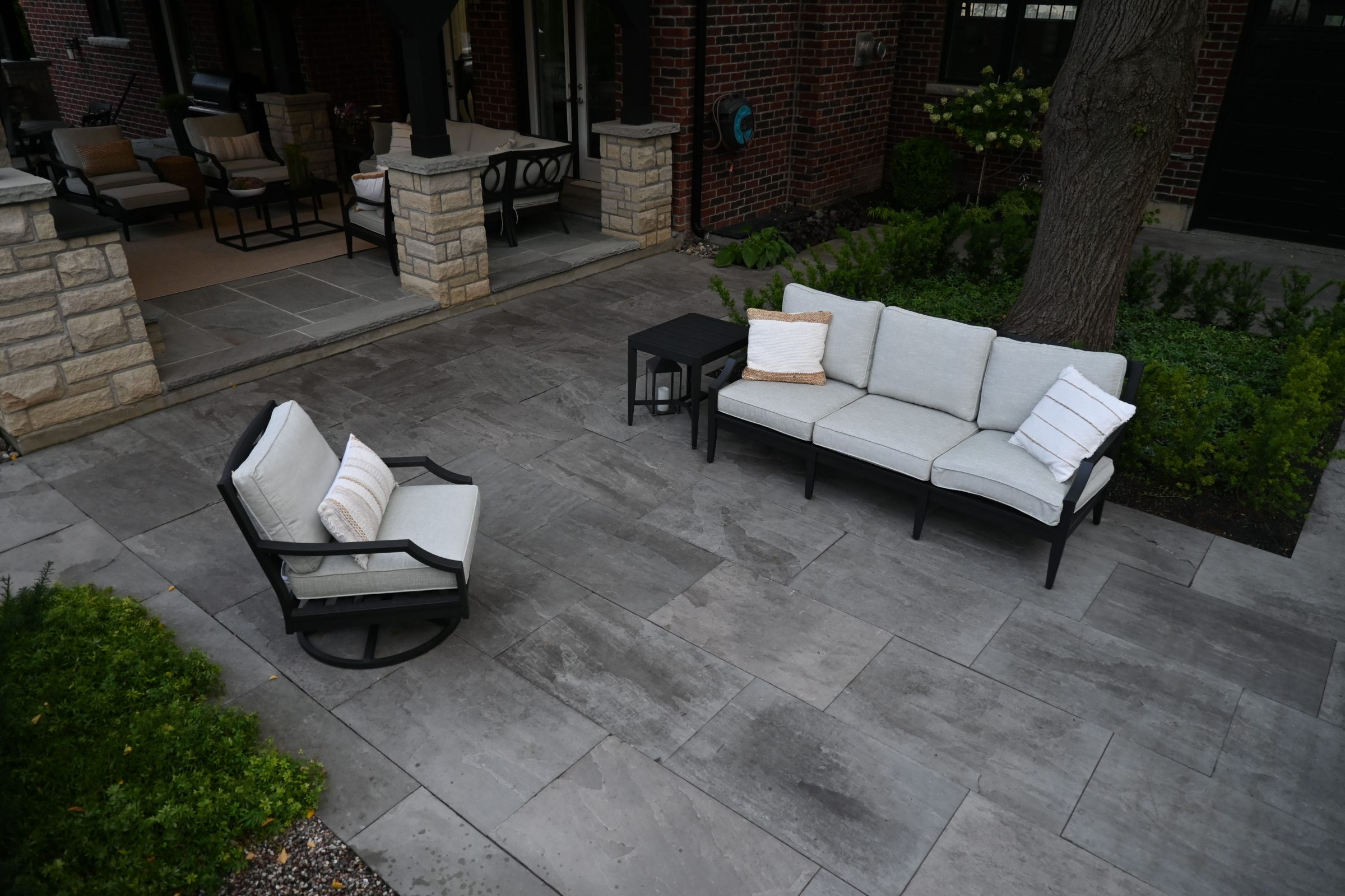 Outdoor patio with modern seating and greenery.