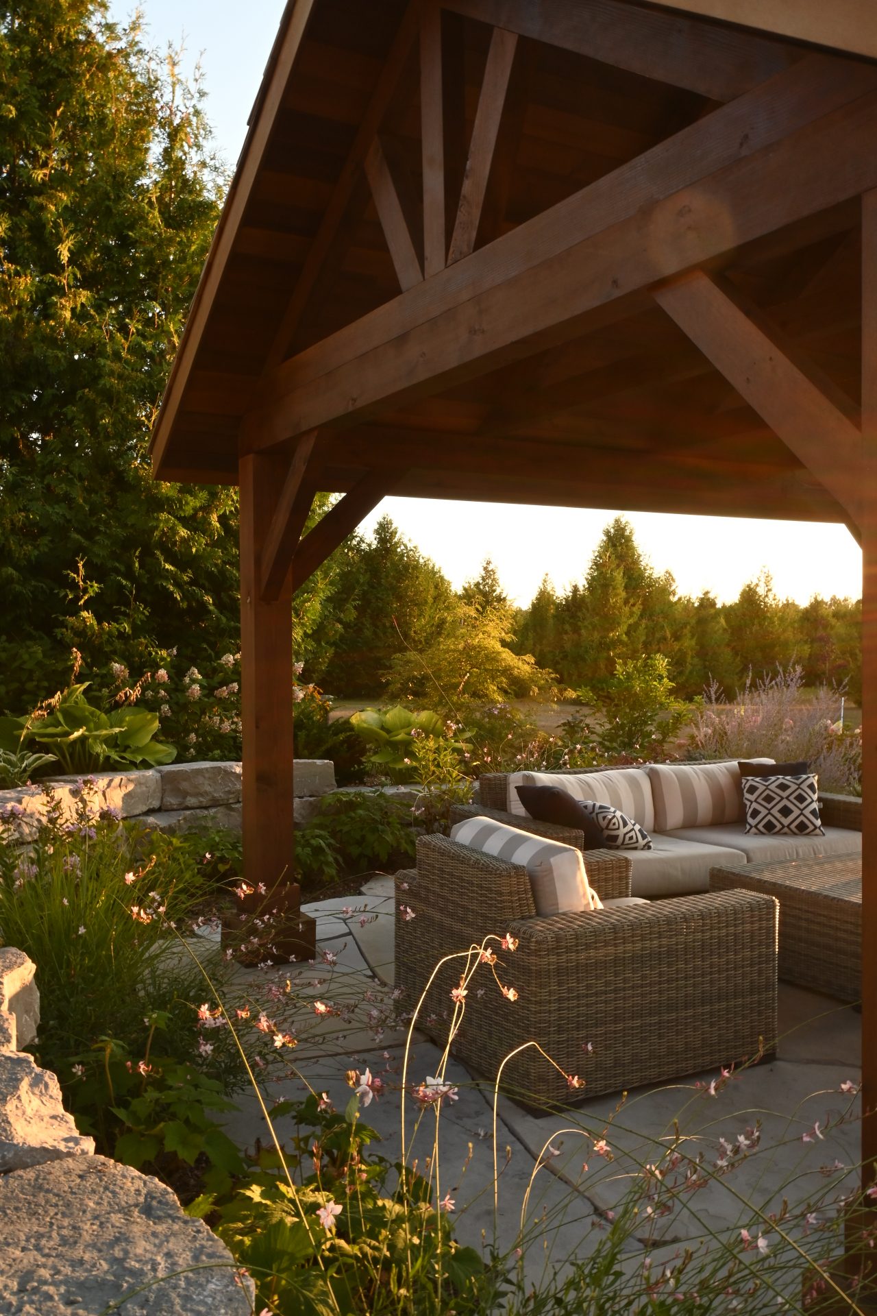 Cozy outdoor patio with wicker furniture at sunset.