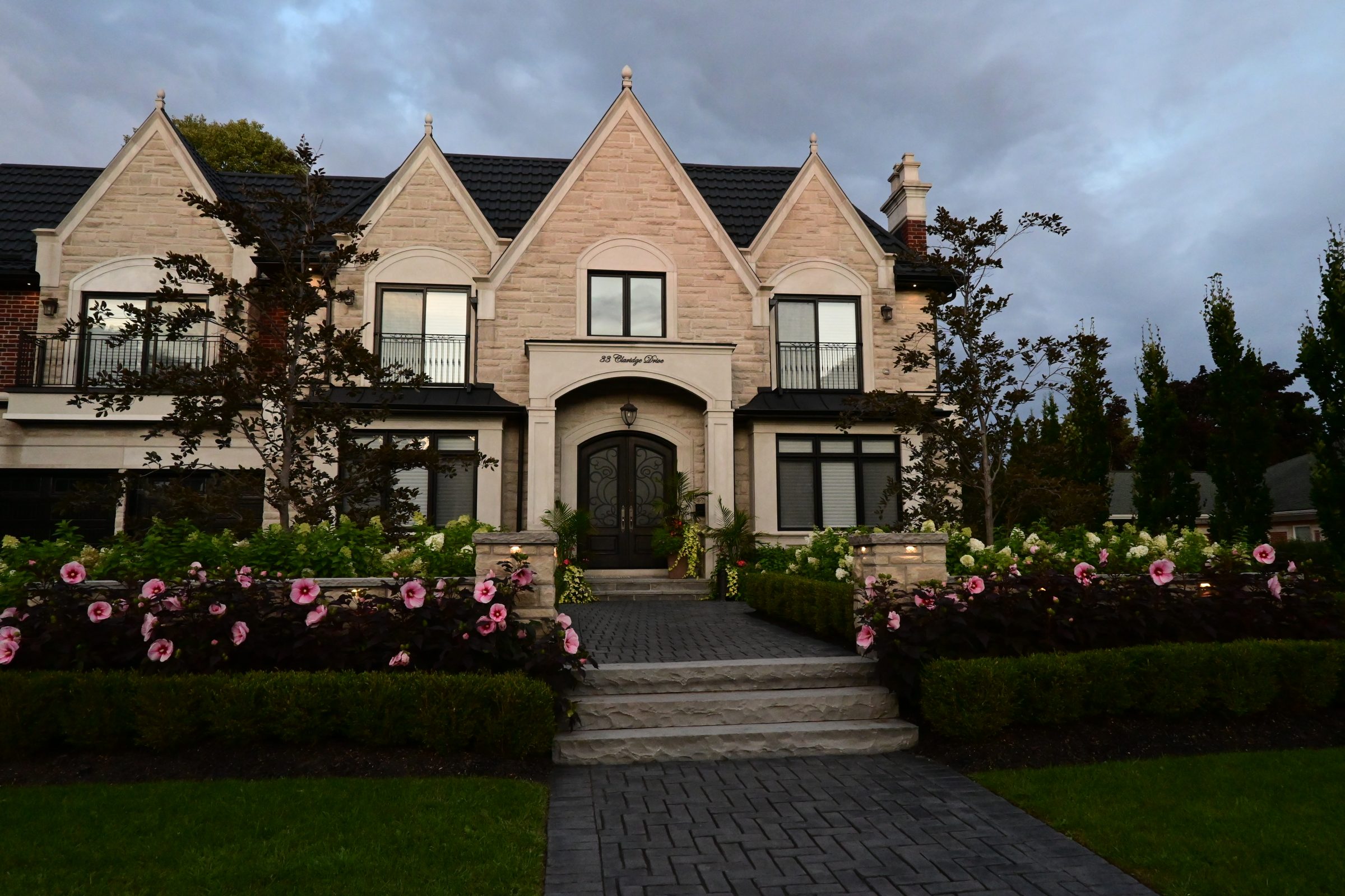 Two-story house with garden and flowers