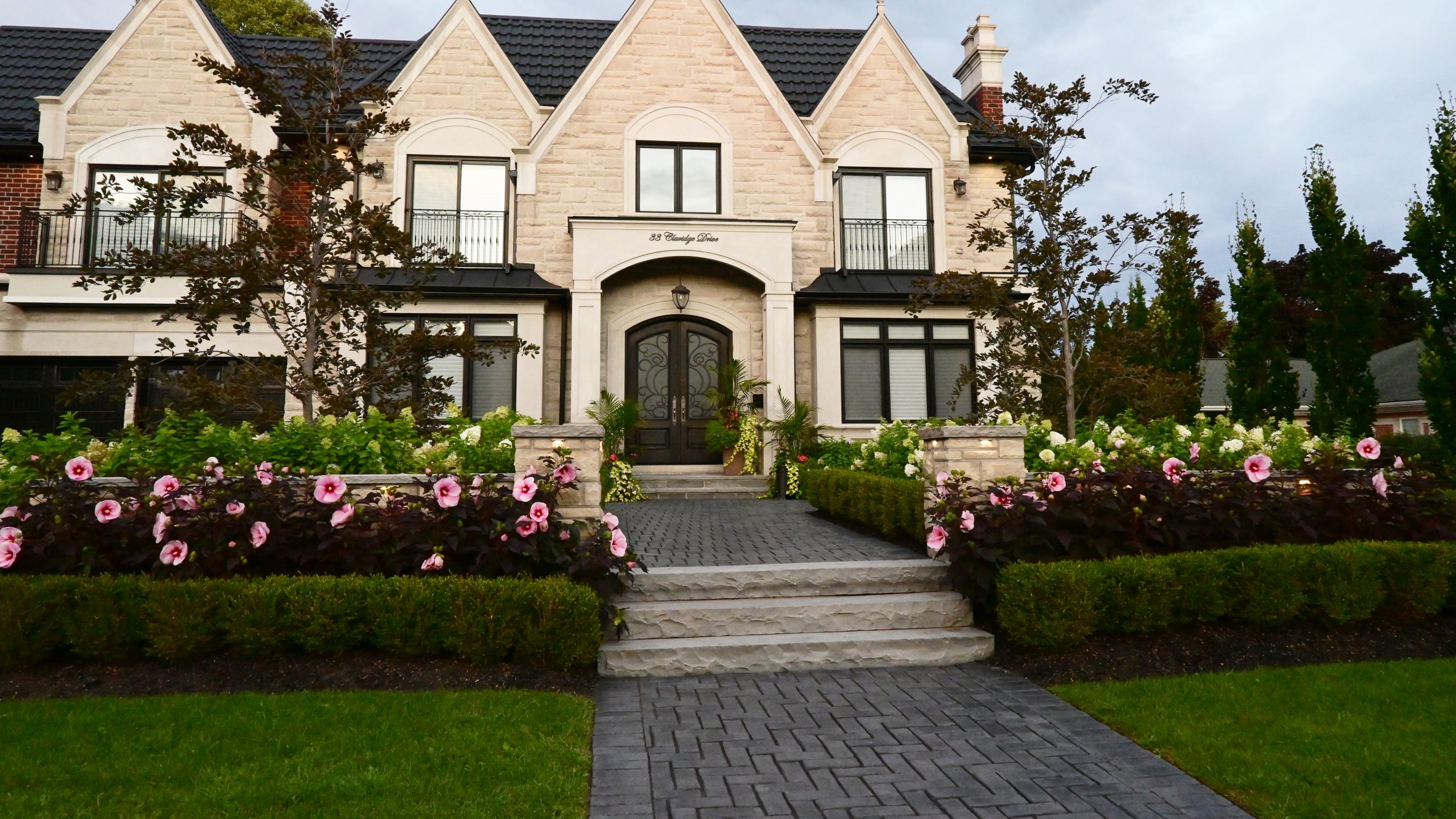 Elegant house with flowers and garden path.