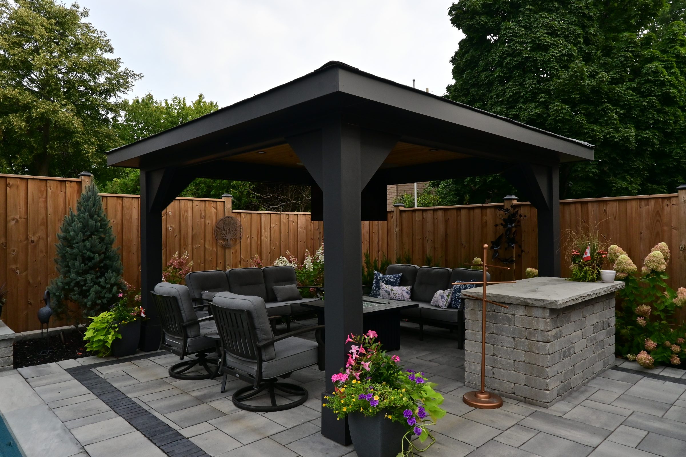 Backyard patio with gazebo and seating area.