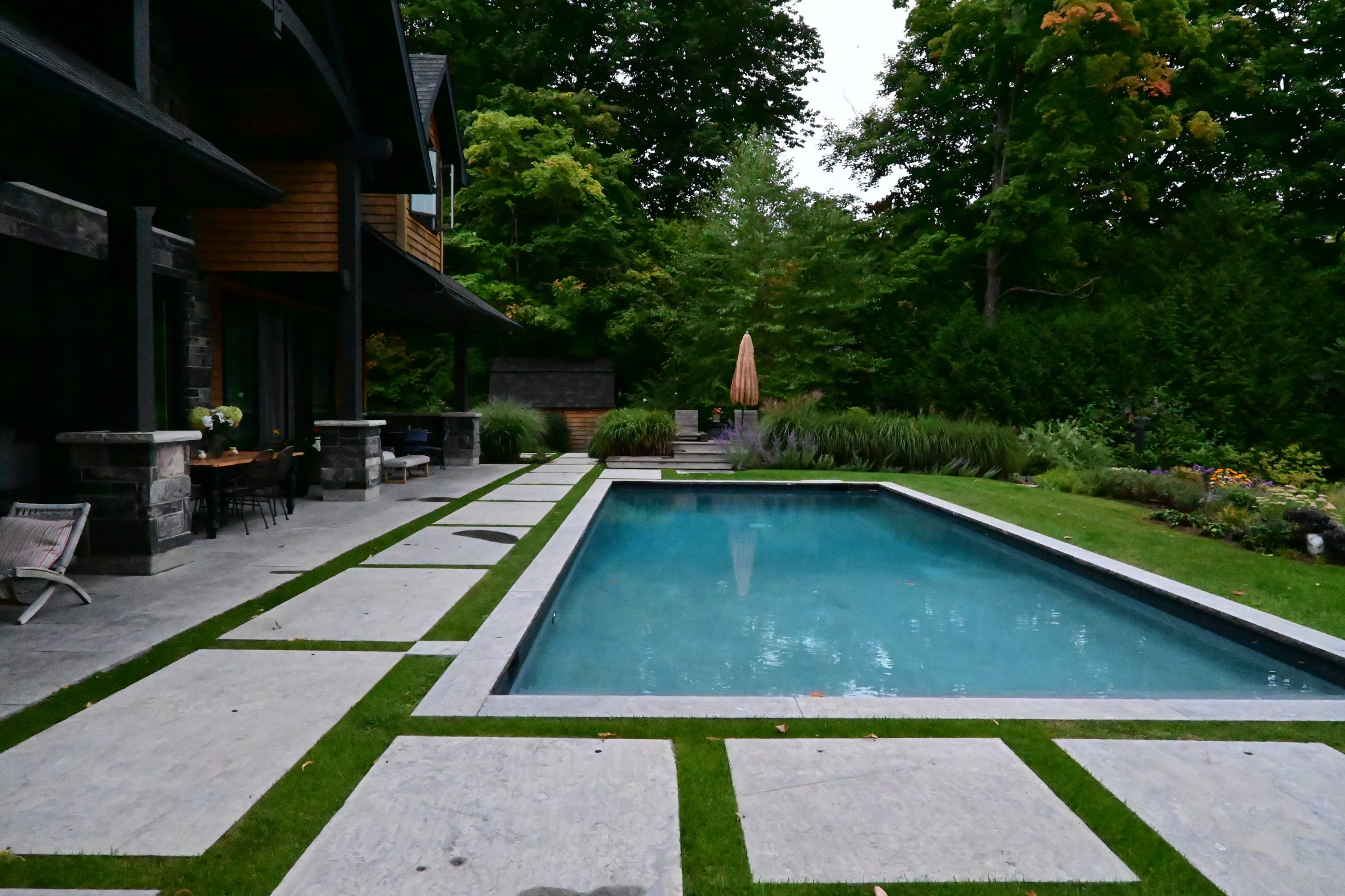 Modern house with pool and lush garden.