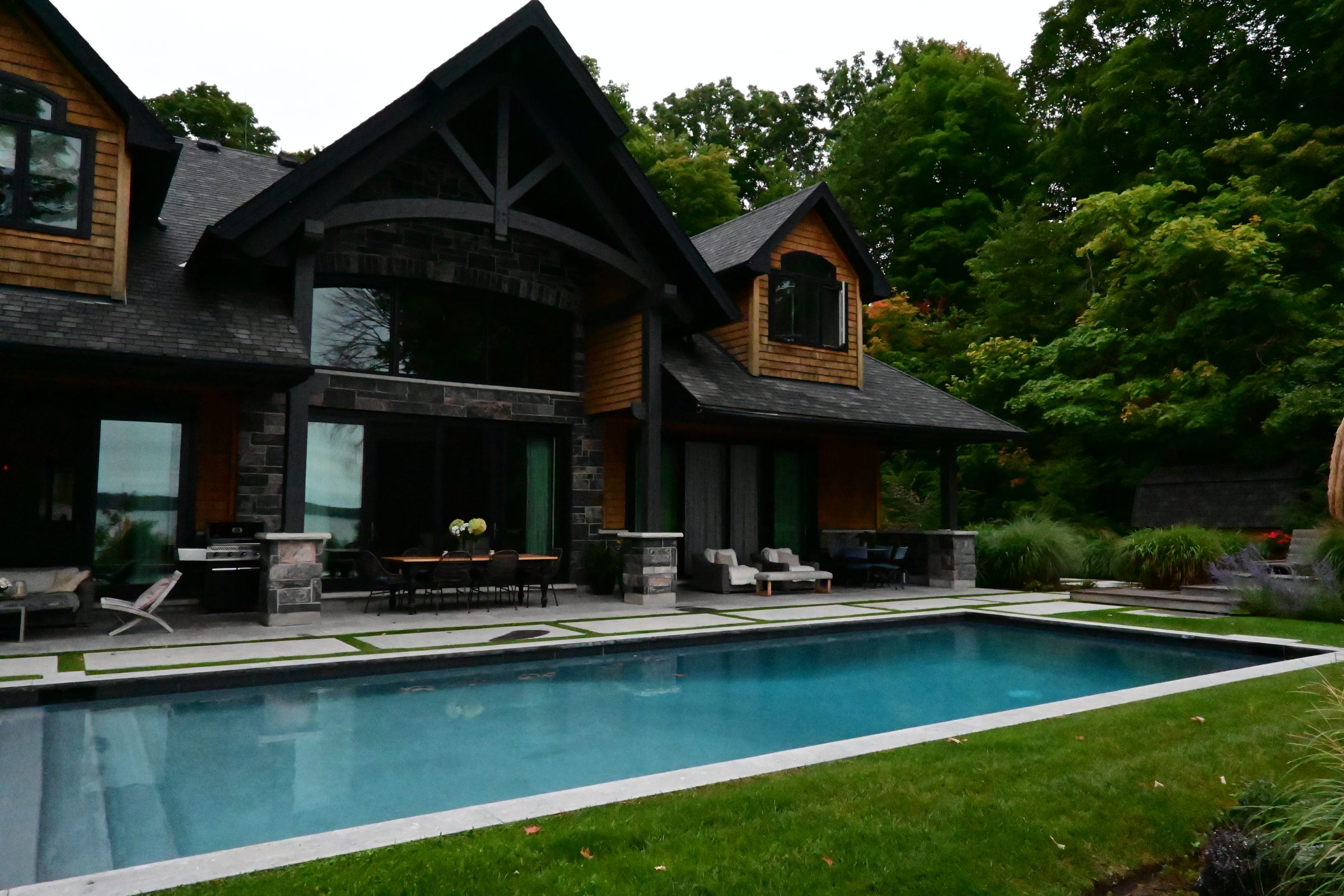 Luxury house with backyard pool and patio area.