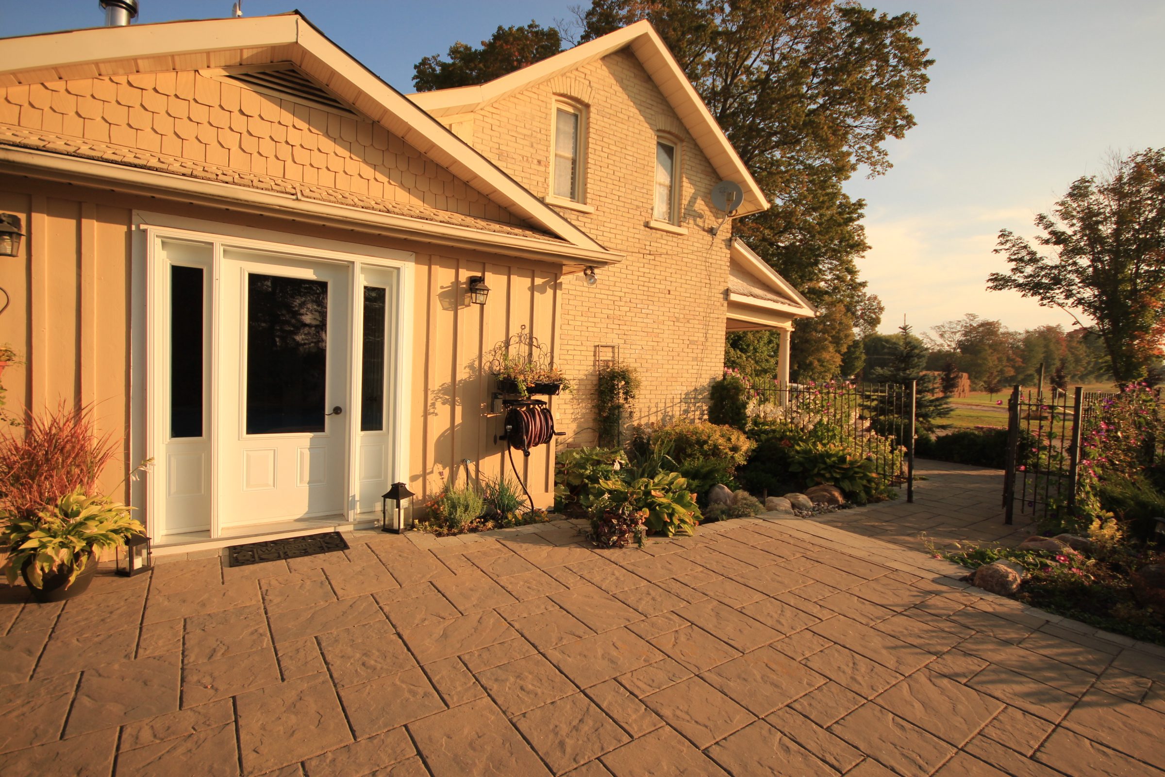 Sunny house entrance with garden path