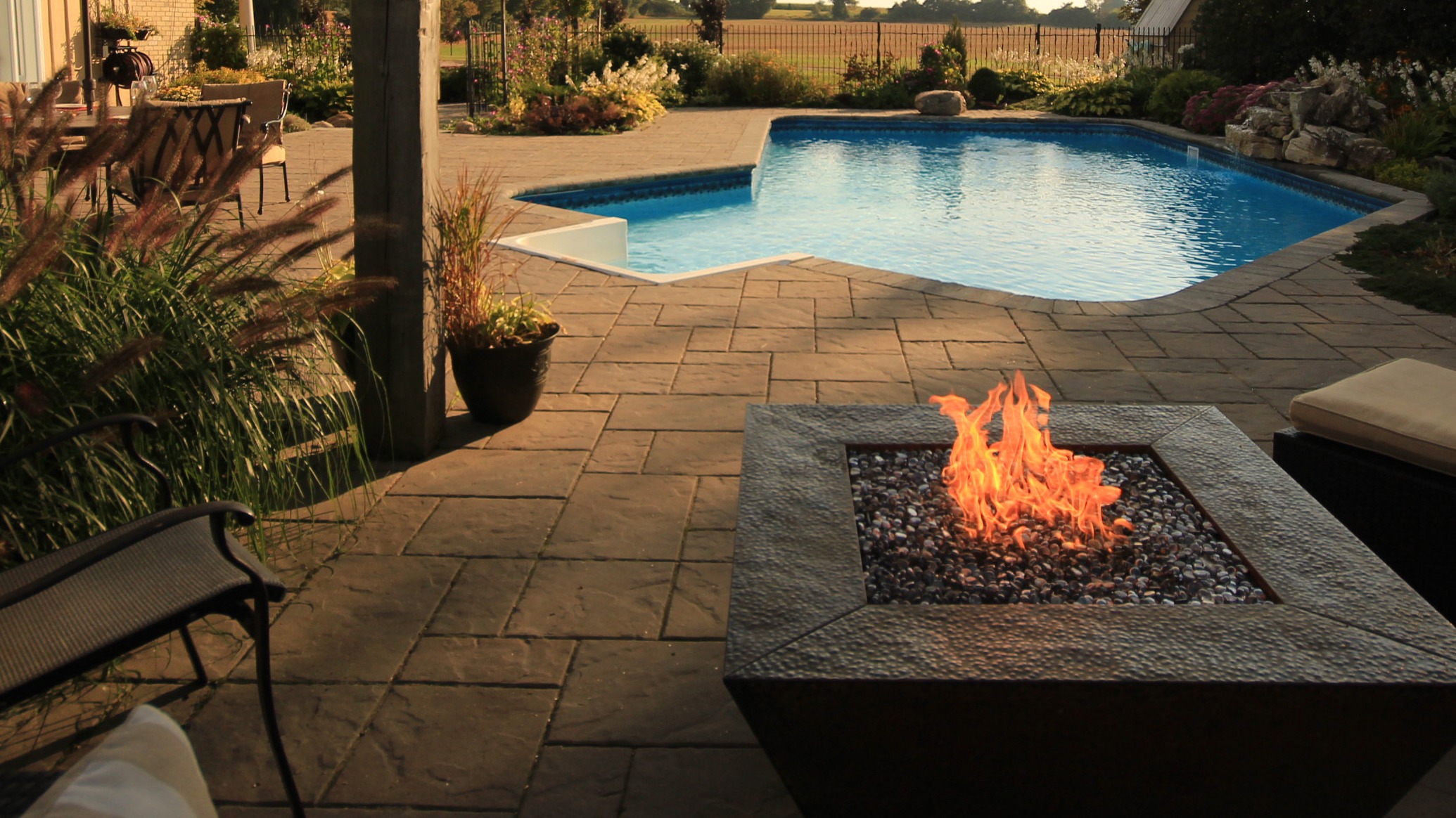 Backyard patio with pool and fire pit.