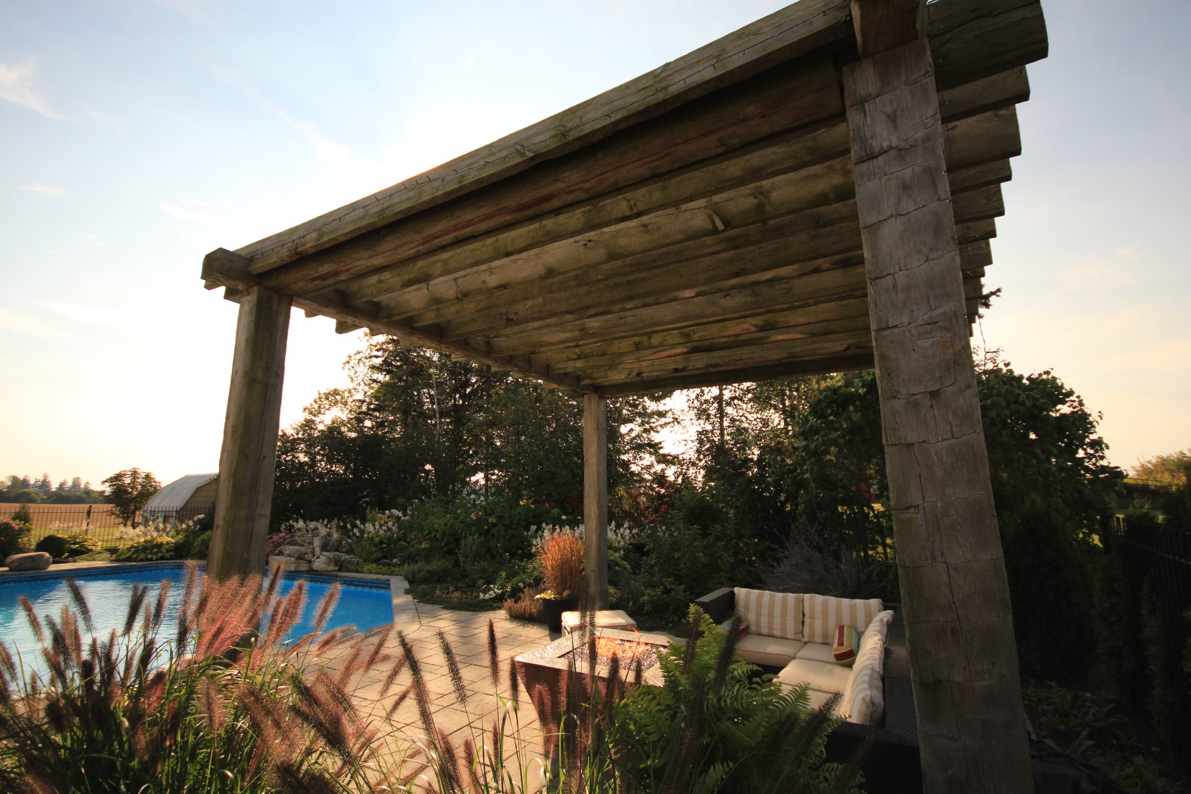 Outdoor patio with pergola and poolside seating