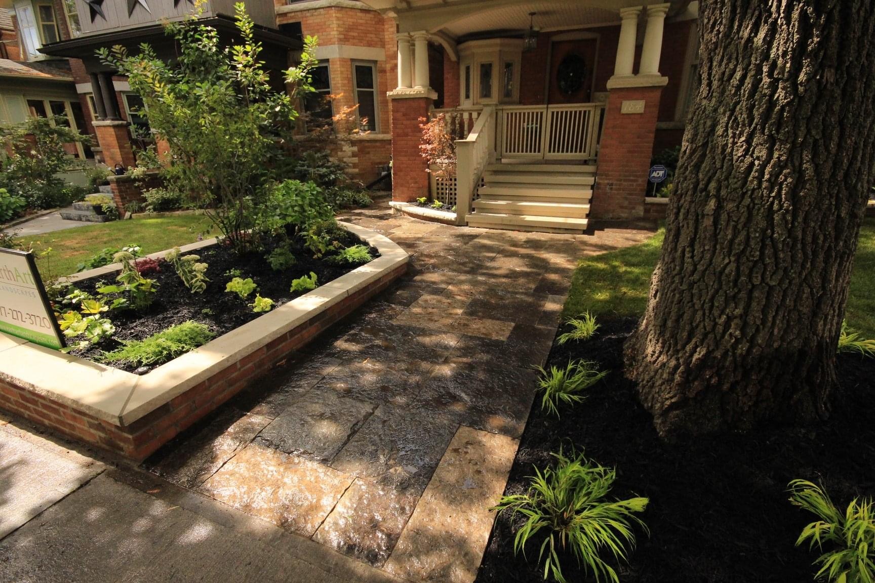 Elegant porch with landscaped garden and tree
