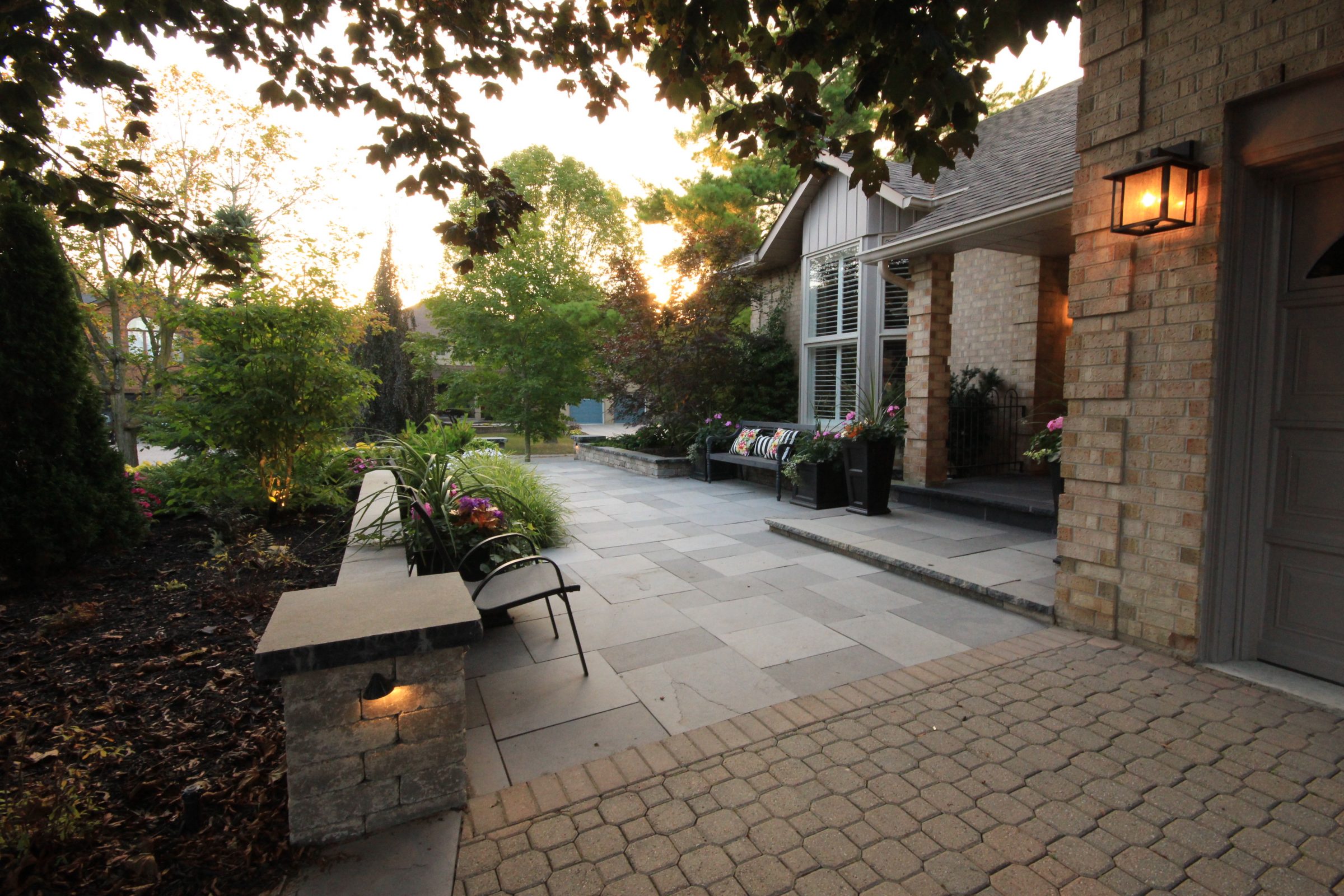 Cozy home entrance with garden view at sunset.