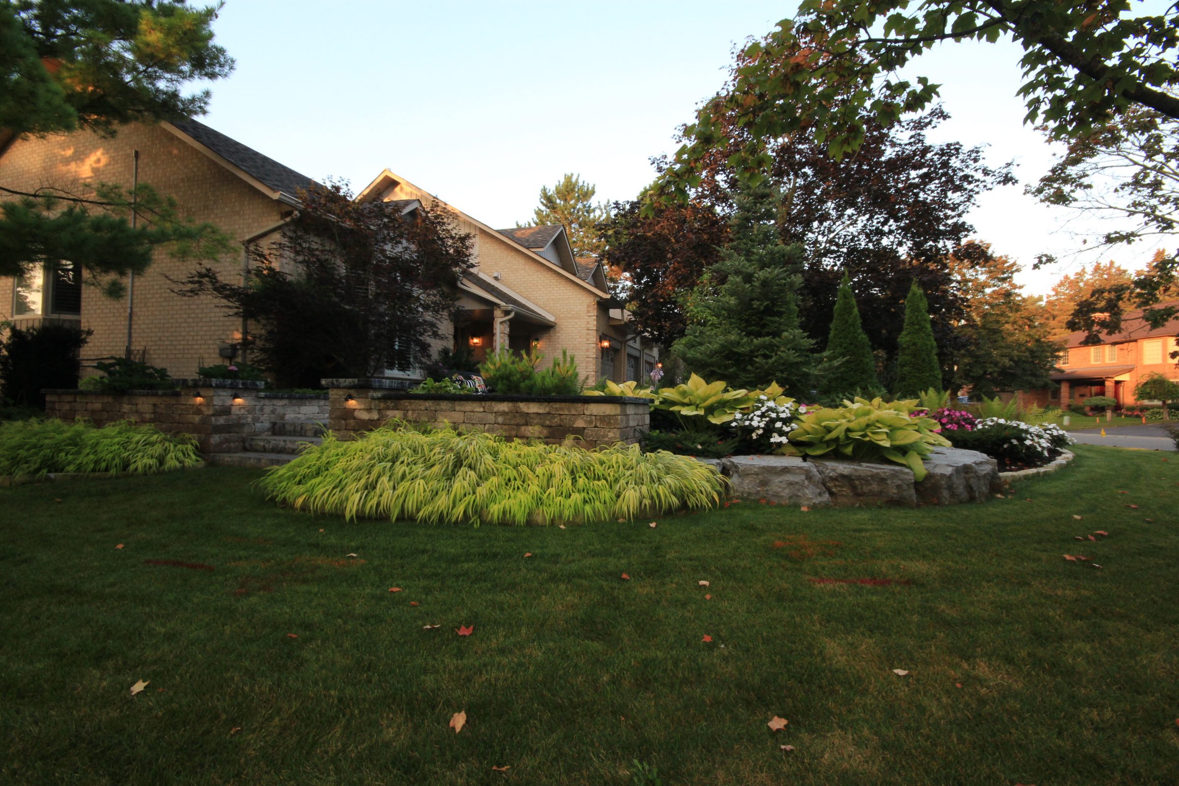 Brick house with landscaped garden in sunlight