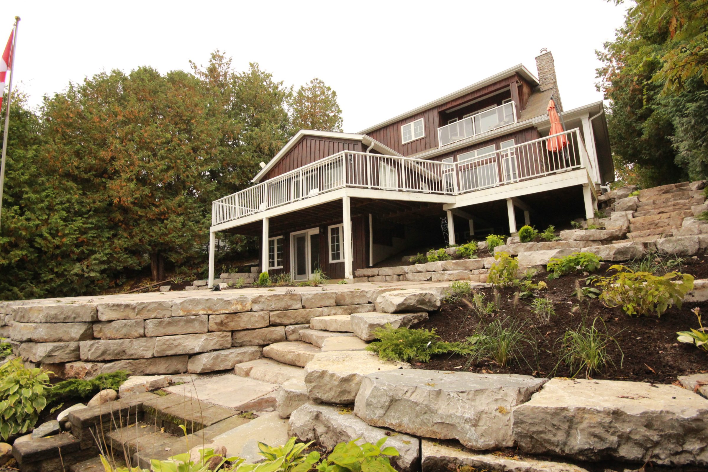 Spacious house with large deck and stone landscaping