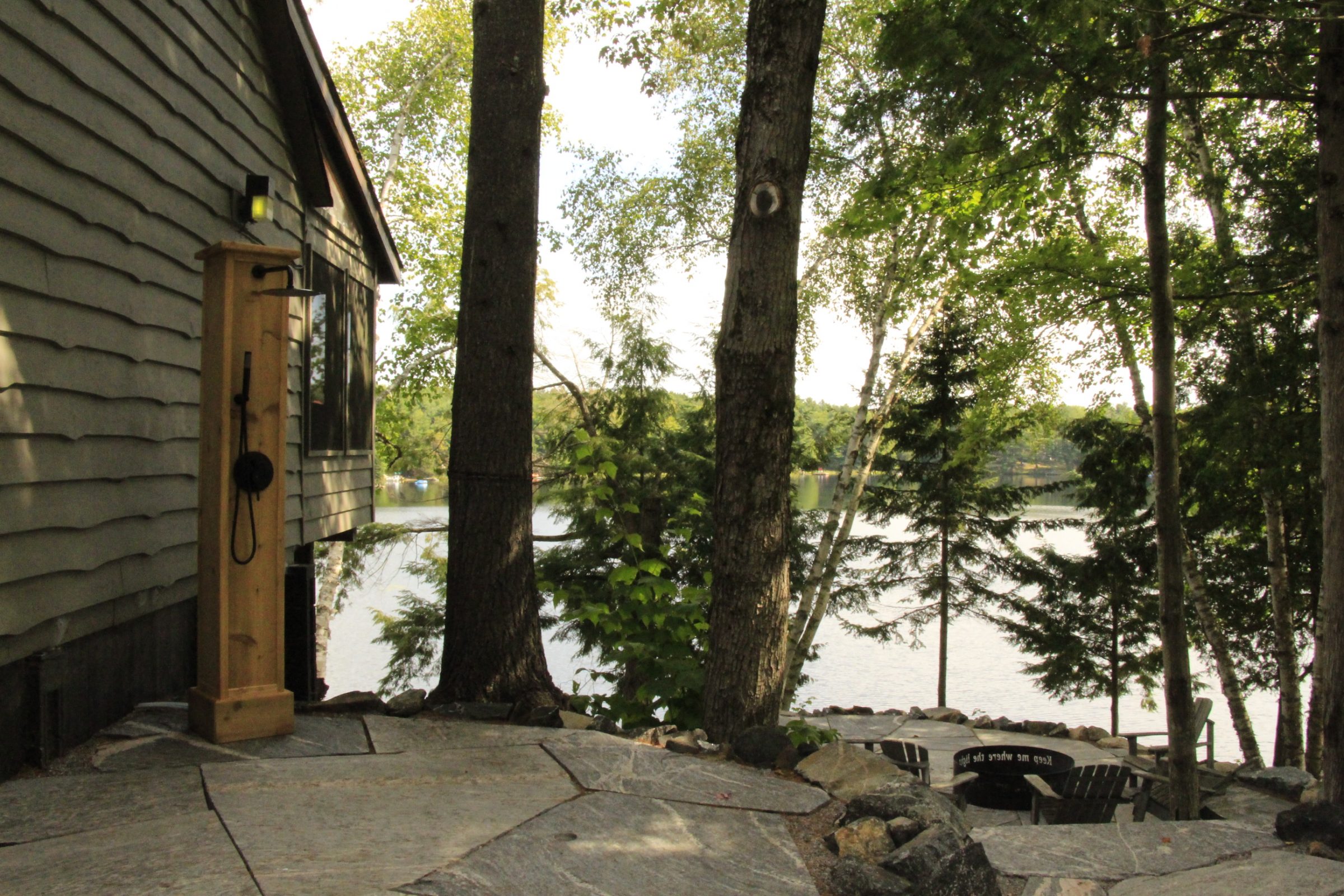 Lakeside patio with stone path and trees
