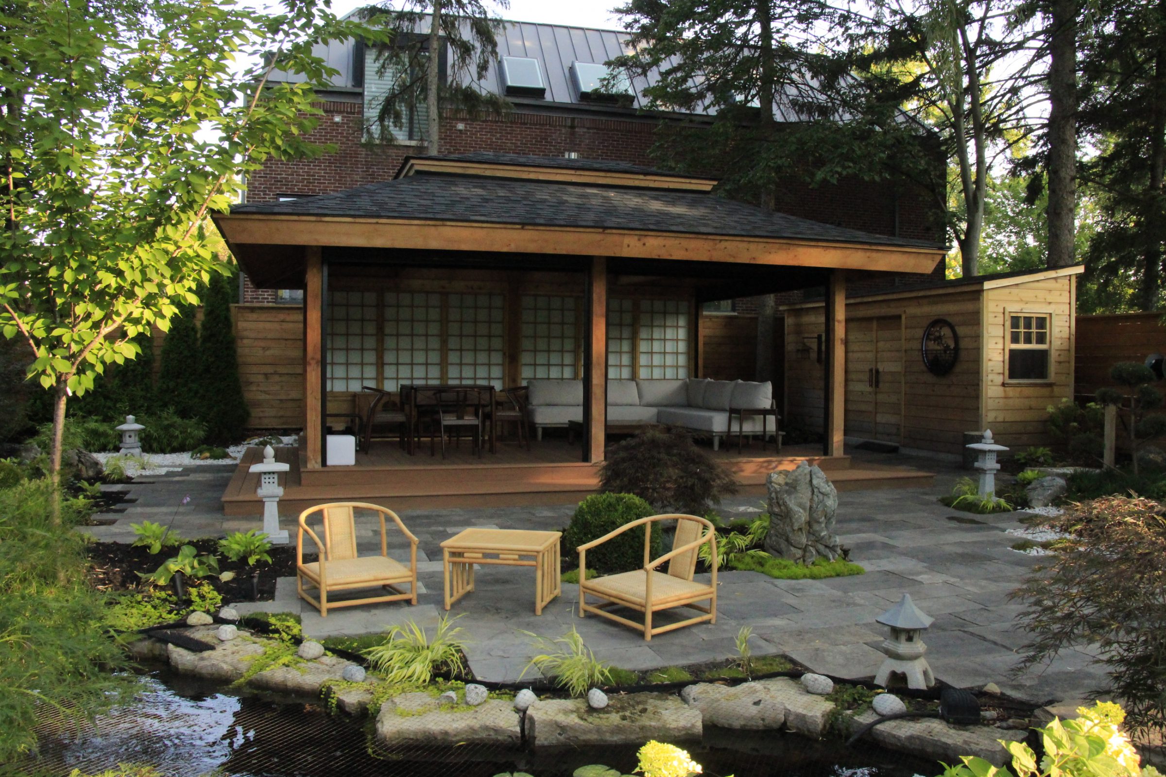 Japanese-style patio with chairs and garden pond.