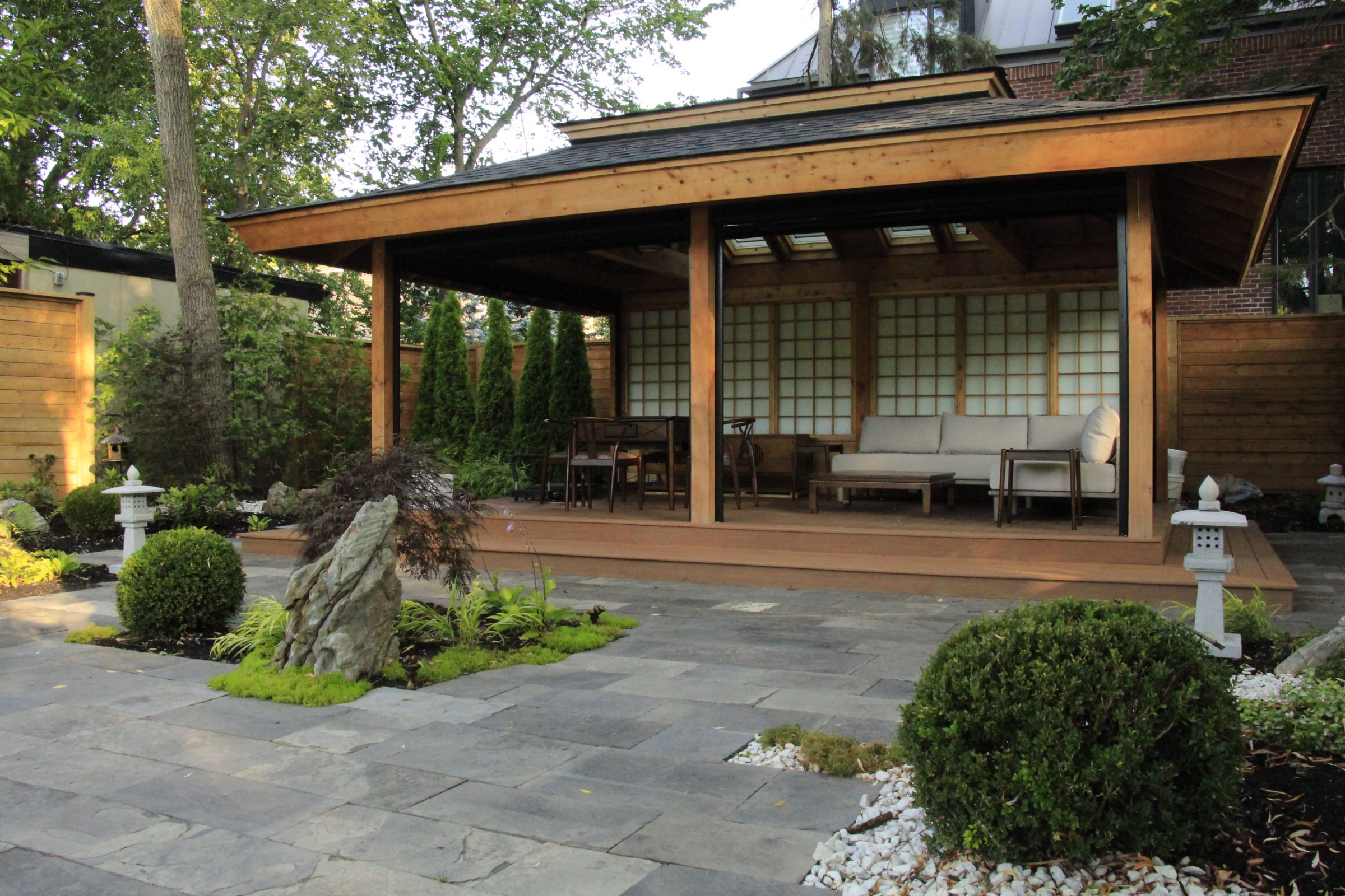 Japanese-inspired garden patio with wooden pergola.