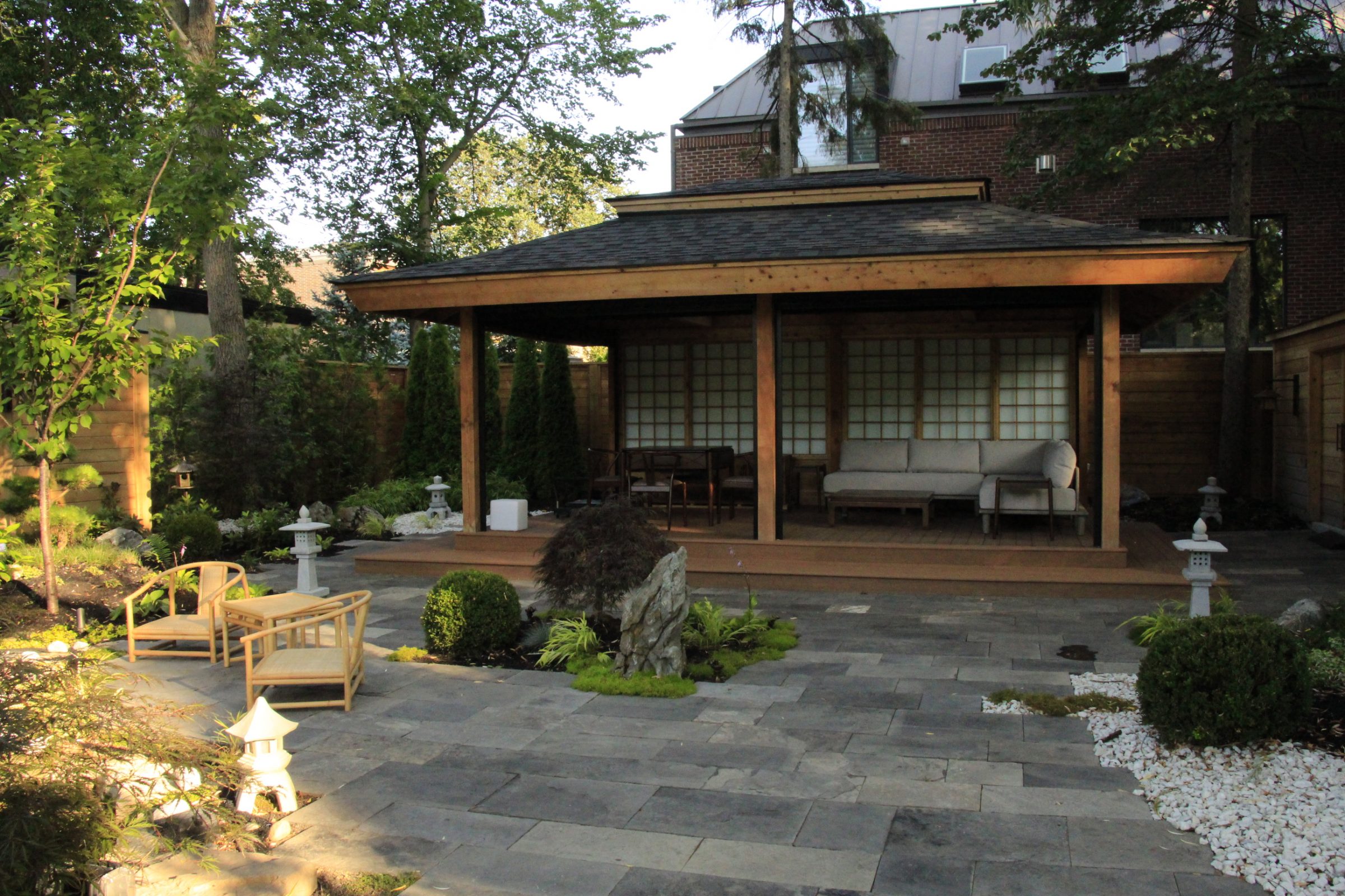 Japanese garden with seating area and pavilion.