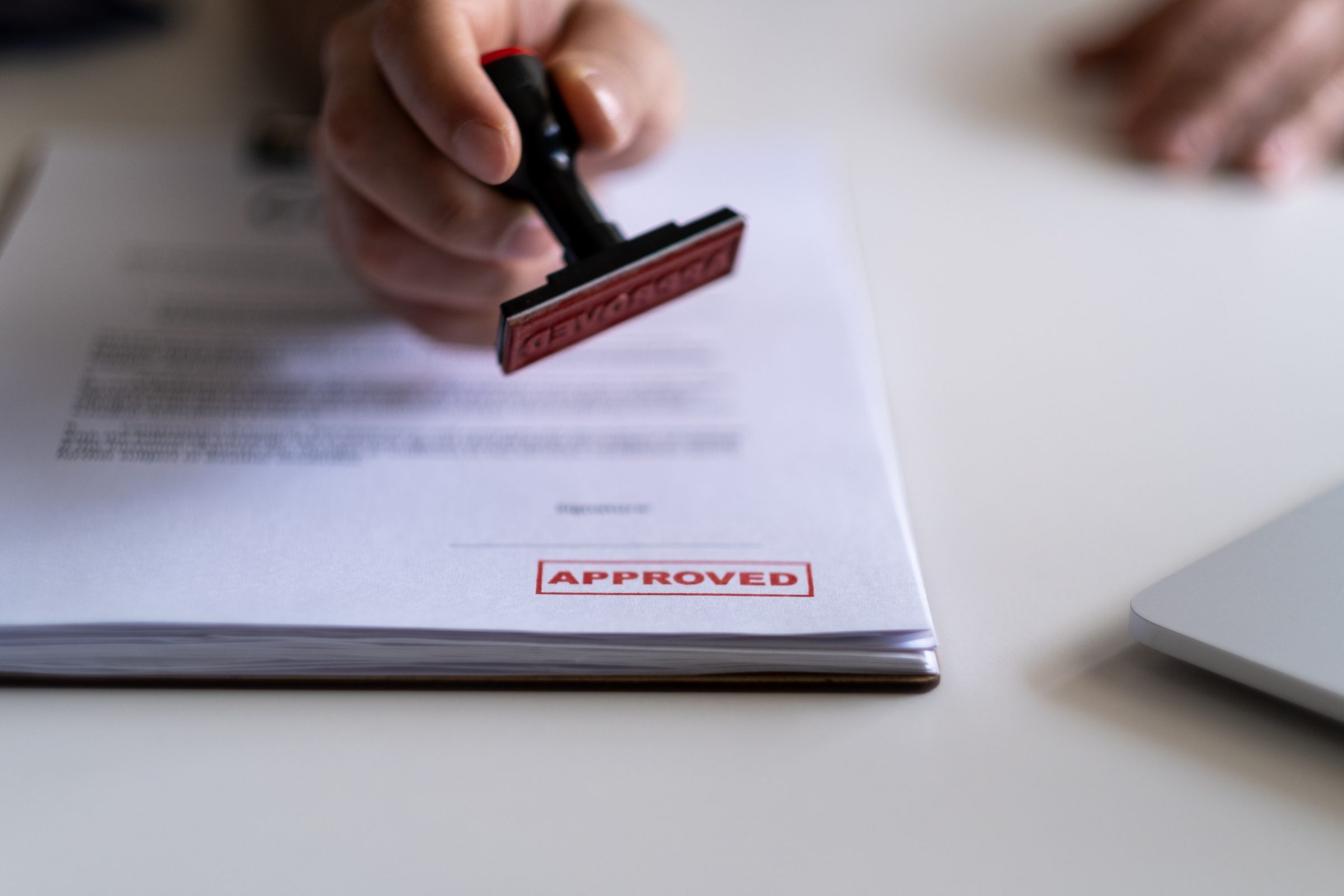 Document stamped as approved with red ink.